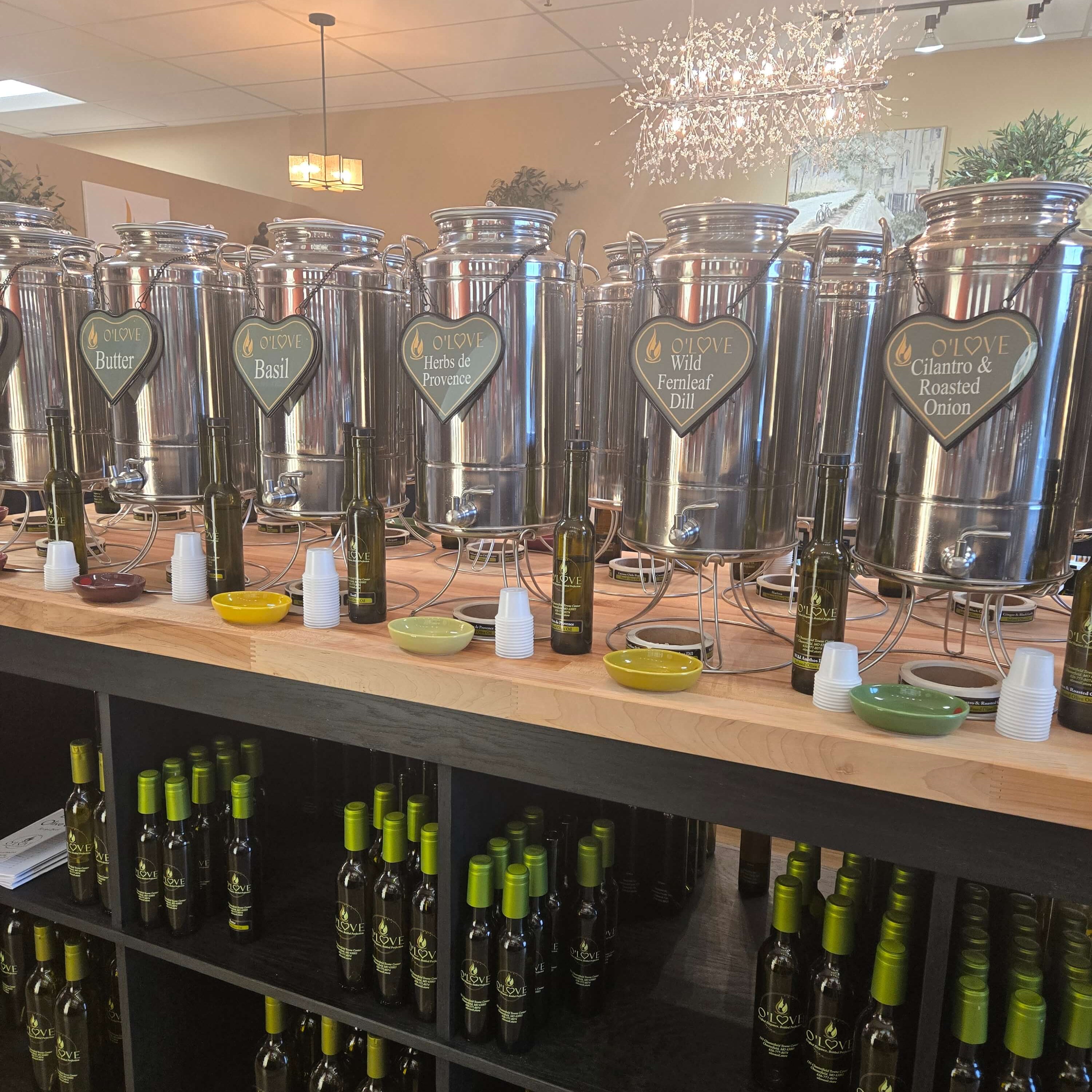 Bottles of olive oil on shelves with decorative elements in a store setting