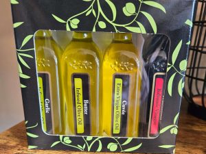Gift set with four bottles, including three olive oils and one balsamic vinegar
